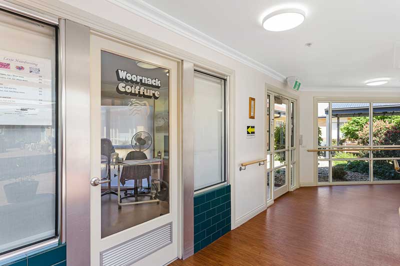 Doutta Galla Woornack - hallway and door to on-site hairdresser "Woornack Coiffure"
